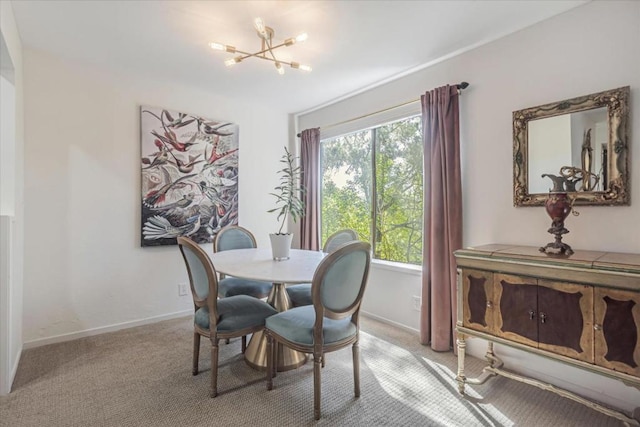 carpeted dining area with a chandelier