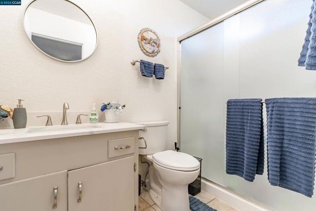 bathroom featuring tile patterned floors, walk in shower, vanity, and toilet