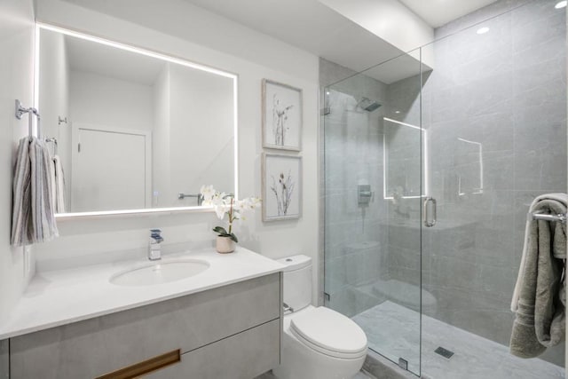 bathroom with vanity, toilet, and an enclosed shower