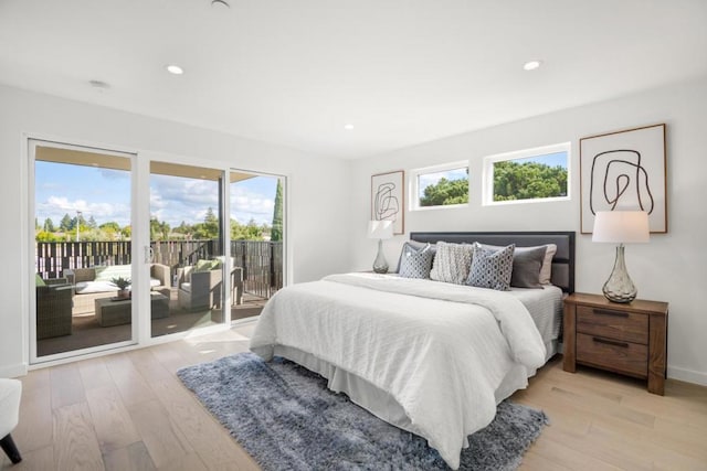 bedroom featuring light wood-type flooring and access to outside