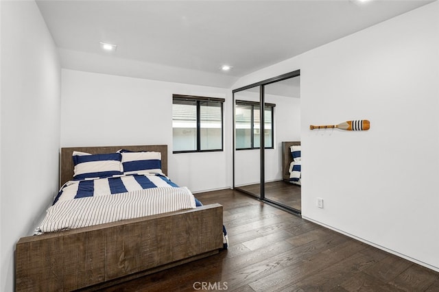 bedroom with a closet and dark hardwood / wood-style floors