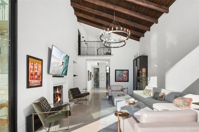 living room featuring high vaulted ceiling, tile patterned flooring, beam ceiling, wood ceiling, and a chandelier