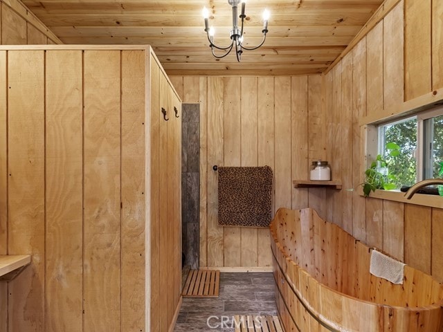 interior space with wooden walls, hardwood / wood-style flooring, and wooden ceiling