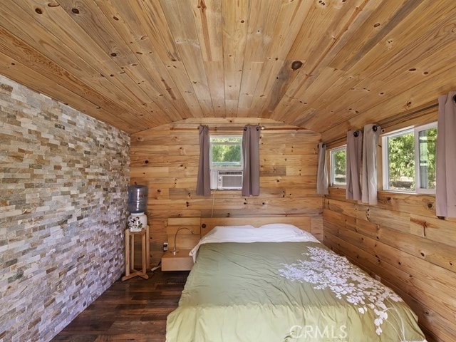 unfurnished bedroom with wood ceiling, dark hardwood / wood-style flooring, cooling unit, vaulted ceiling, and wooden walls