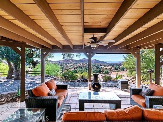 view of patio / terrace featuring outdoor lounge area, a mountain view, and ceiling fan