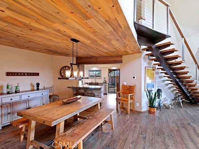 dining area with wooden ceiling, an inviting chandelier, and hardwood / wood-style floors