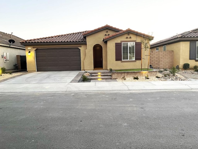 mediterranean / spanish house with a garage