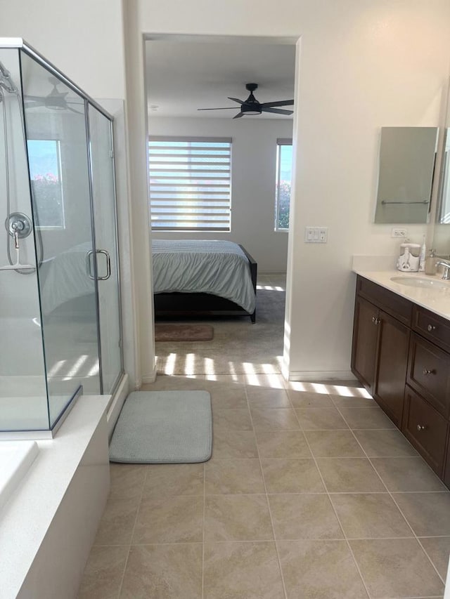 bathroom with vanity, a shower with door, tile patterned floors, and ceiling fan