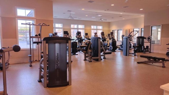 gym featuring ceiling fan and a towering ceiling