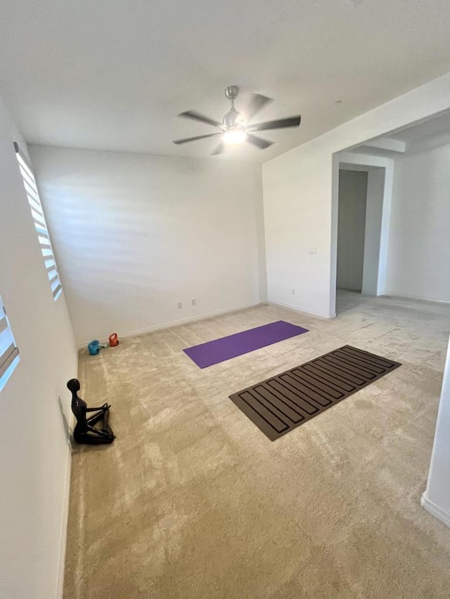 empty room with carpet, ceiling fan, and basketball court