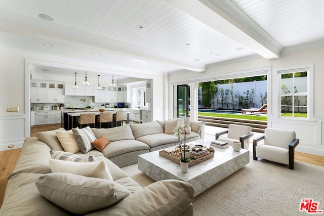 living room with beam ceiling, light wood-type flooring, and wood ceiling