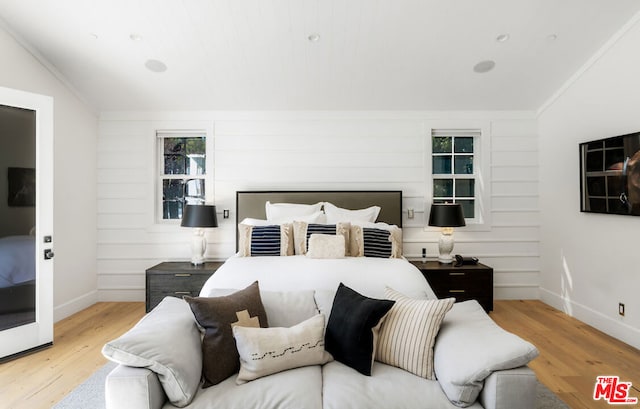 bedroom featuring light hardwood / wood-style floors and ornamental molding