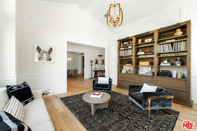 living area with beamed ceiling, hardwood / wood-style flooring, high vaulted ceiling, and a notable chandelier