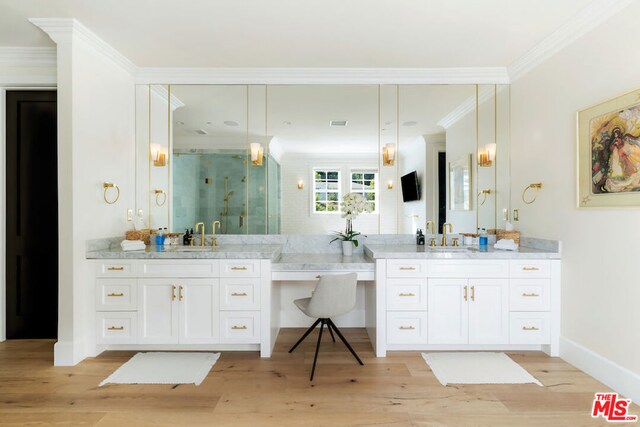 bathroom featuring walk in shower, hardwood / wood-style floors, vanity, and ornamental molding