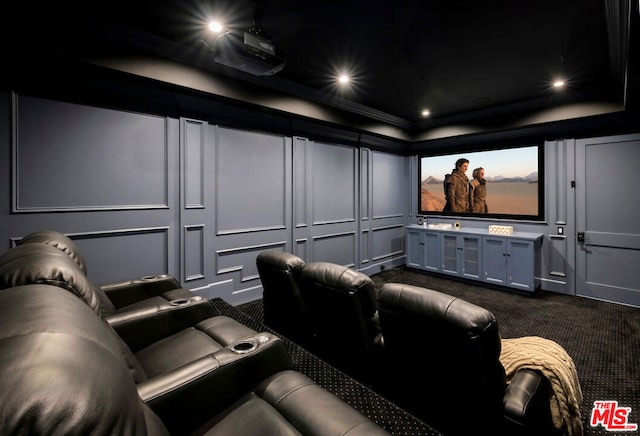 home theater featuring dark carpet and ornamental molding