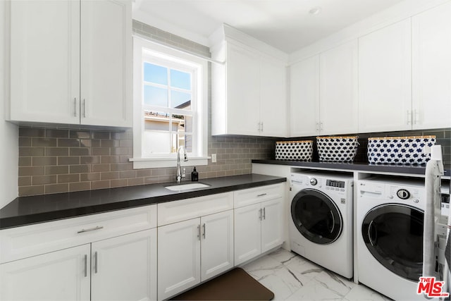 laundry area with cabinets, independent washer and dryer, and sink