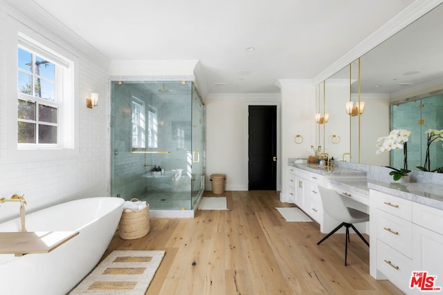 bathroom featuring wood-type flooring, vanity, shower with separate bathtub, and ornamental molding