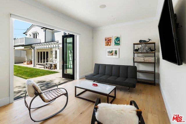 living room with french doors, light wood-type flooring, and ornamental molding