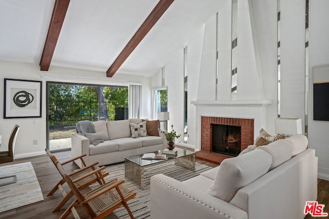 living room with vaulted ceiling with beams, a fireplace, and dark hardwood / wood-style floors