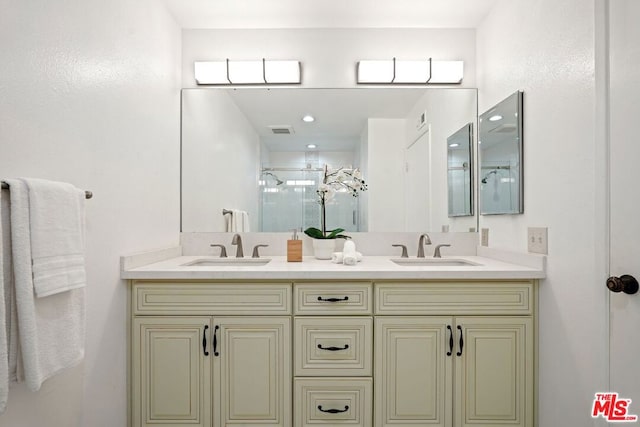 bathroom featuring vanity and an enclosed shower