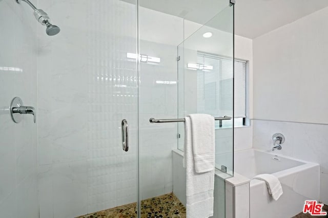 bathroom with shower with separate bathtub