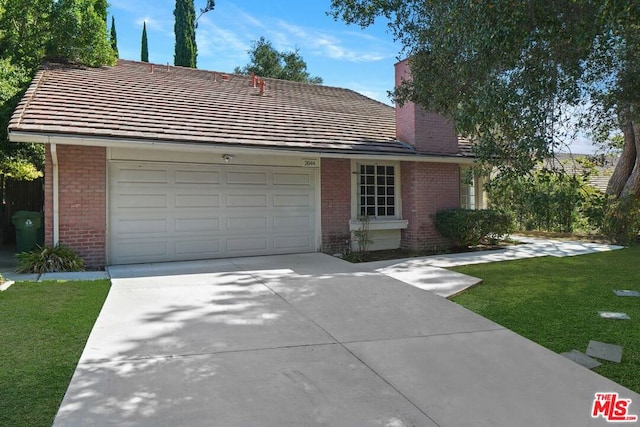 ranch-style house with a garage and a front yard