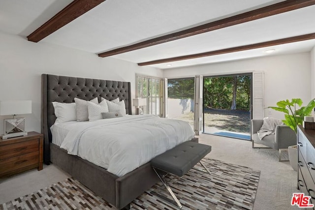 carpeted bedroom featuring beam ceiling and access to exterior