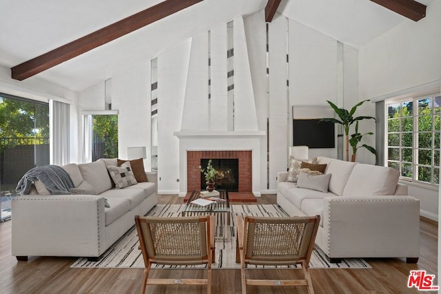 living room featuring beam ceiling, hardwood / wood-style flooring, high vaulted ceiling, and plenty of natural light