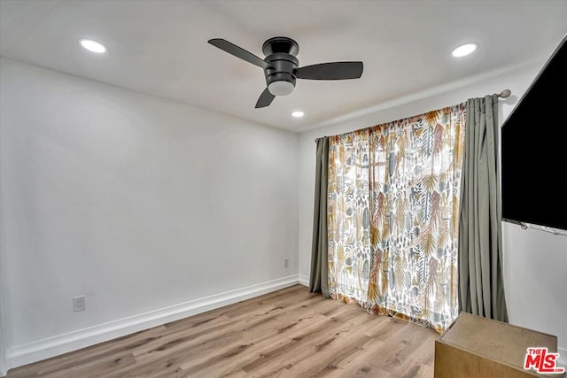 unfurnished room featuring light wood-type flooring and ceiling fan