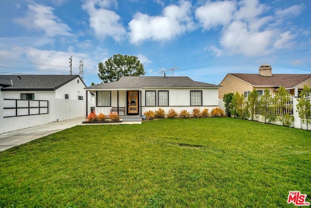 ranch-style home featuring a front yard and a porch