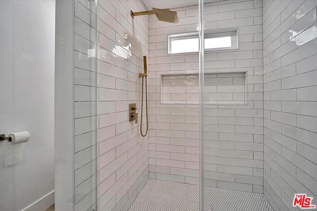 bathroom with a shower with door