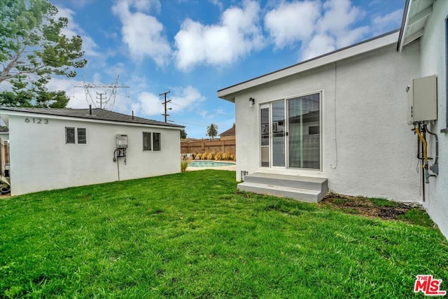 view of yard with a fenced in pool