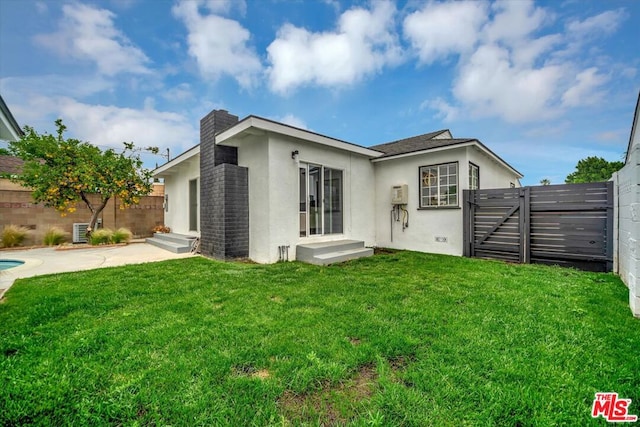 rear view of house with a lawn