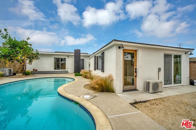 view of pool featuring central air condition unit, ac unit, and a patio