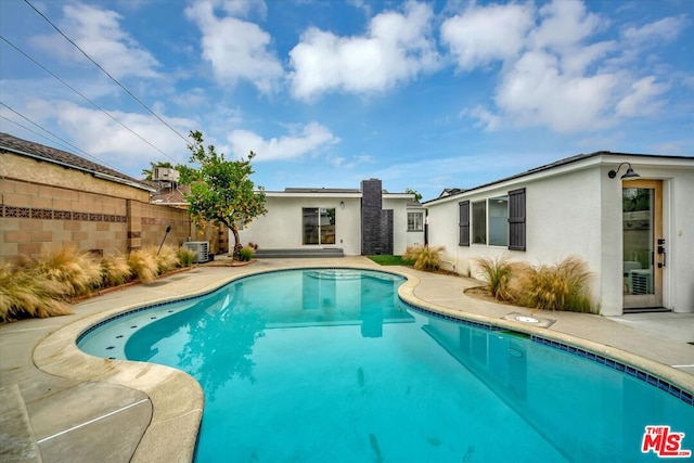 view of swimming pool with a patio and central AC unit