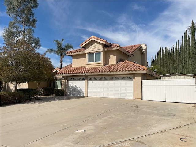 mediterranean / spanish-style house with a garage