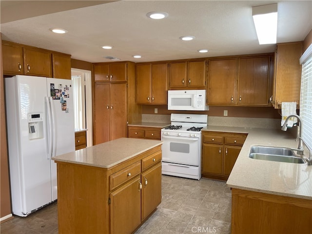 kitchen with sink, a center island, and white appliances