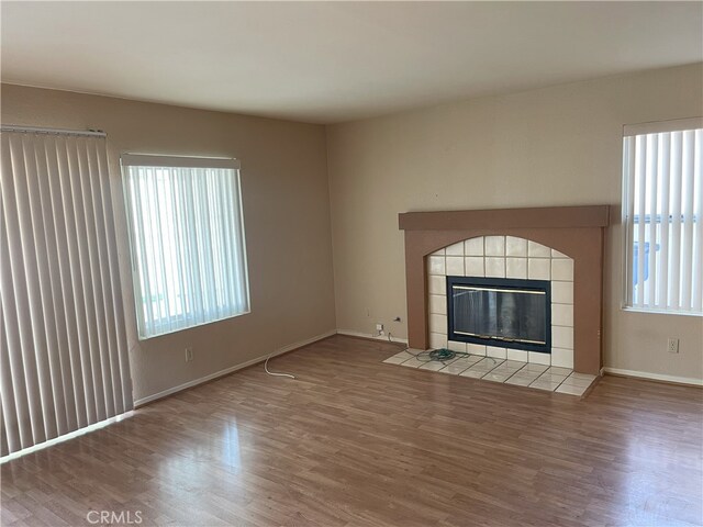 unfurnished living room featuring hardwood / wood-style floors and a fireplace