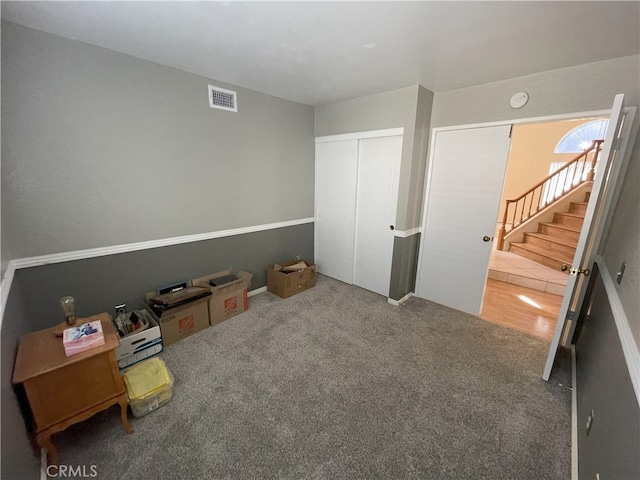 interior space with a closet and carpet flooring