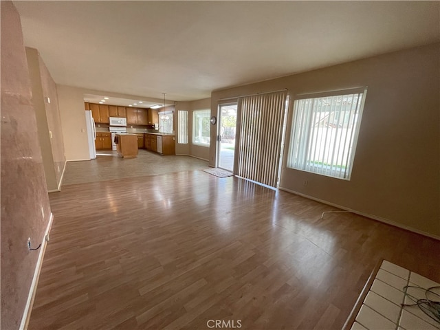 unfurnished living room with dark hardwood / wood-style floors