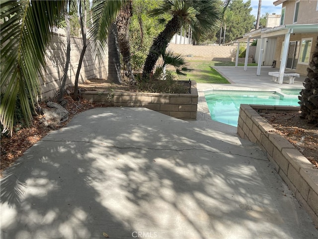 view of swimming pool with a patio