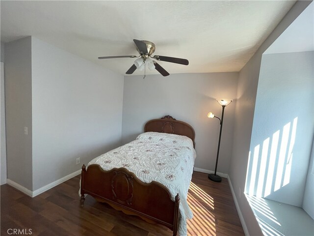 bedroom with dark hardwood / wood-style floors and ceiling fan