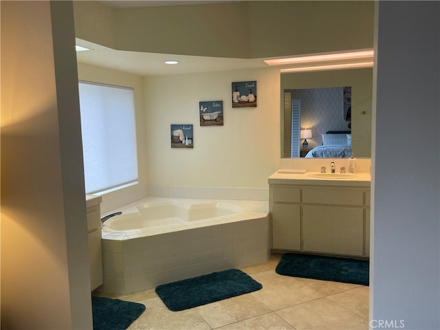 bathroom with vanity, tile patterned floors, and tiled tub