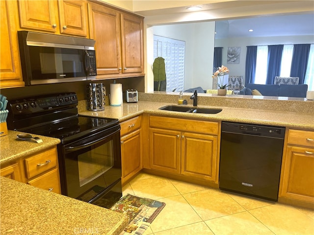 kitchen with light tile patterned flooring, black appliances, and sink