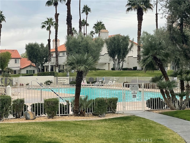 view of pool with a yard