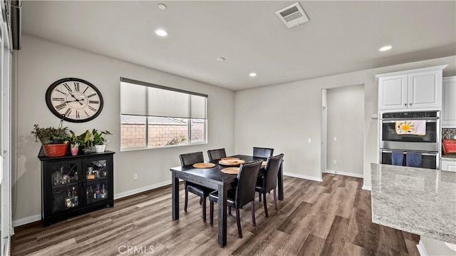 dining space featuring dark hardwood / wood-style flooring