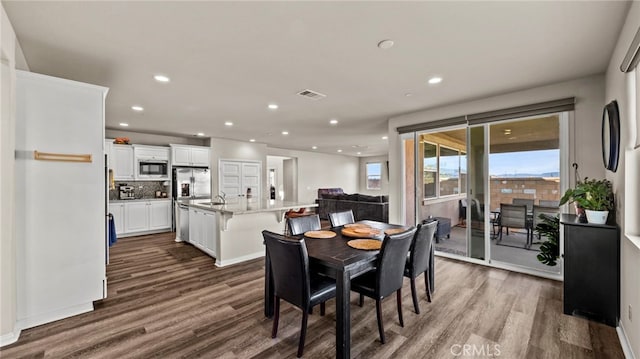 dining room featuring dark wood-type flooring and sink