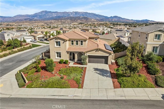 view of front of property featuring a mountain view and a garage