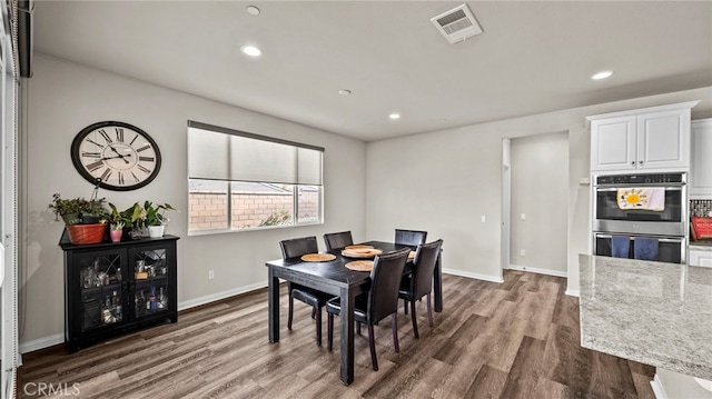 dining area with dark hardwood / wood-style flooring