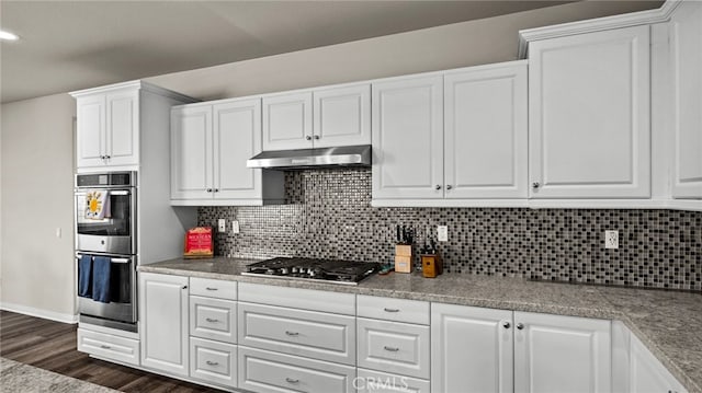 kitchen featuring decorative backsplash, white cabinetry, dark hardwood / wood-style floors, and stainless steel appliances